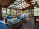The sitting area connected to the dining area on the screened in porch.